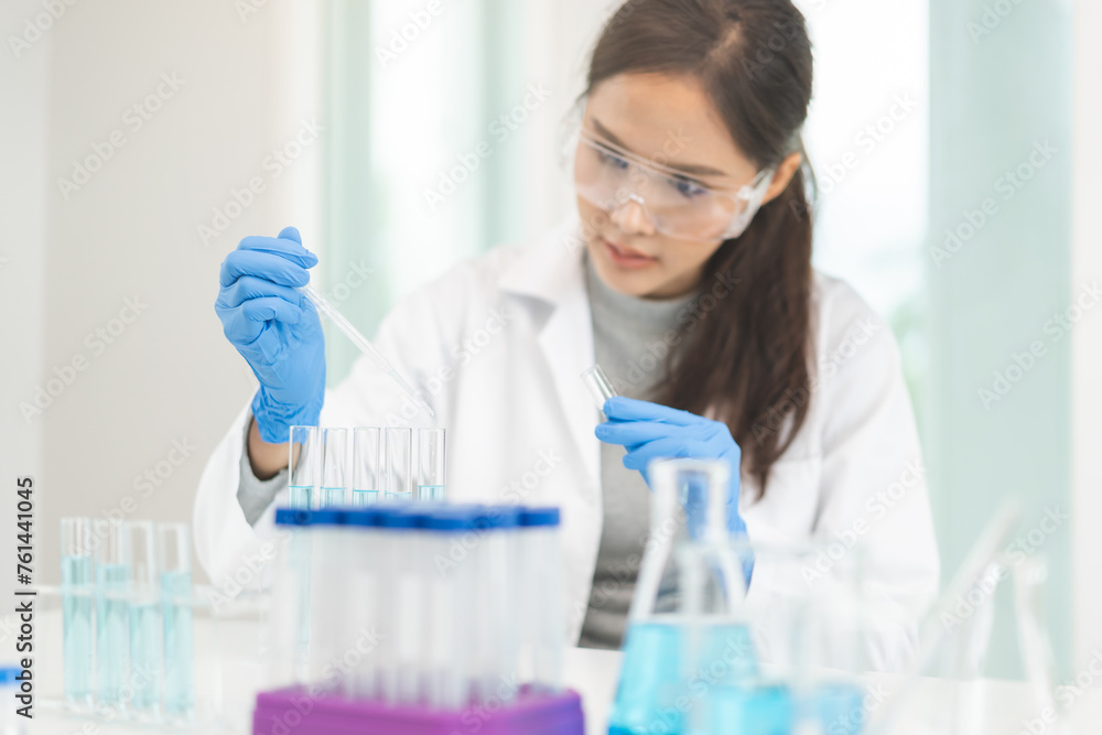 Medical development research laboratory, chemist or science scientist student hand in glove, drop water into pipette for test analysis liquid sample in clinic lab. Microbiology, analysing for medicine Medical development research laboratory, chemist or science scientist student hand in glove, drop water into pipette for test analysis liquid sample in clinic lab. Microbiology, analysing for medicine