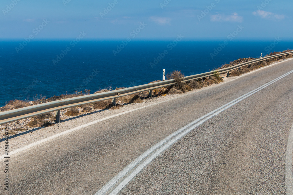 serpentine road in the mountains along the sea on the island of Santorini in Greece