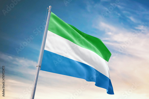 Obraz na plátne Waving flag of Sierra Leone in blue sky