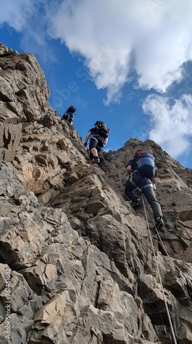 Climbers ascending a steep rocky slope