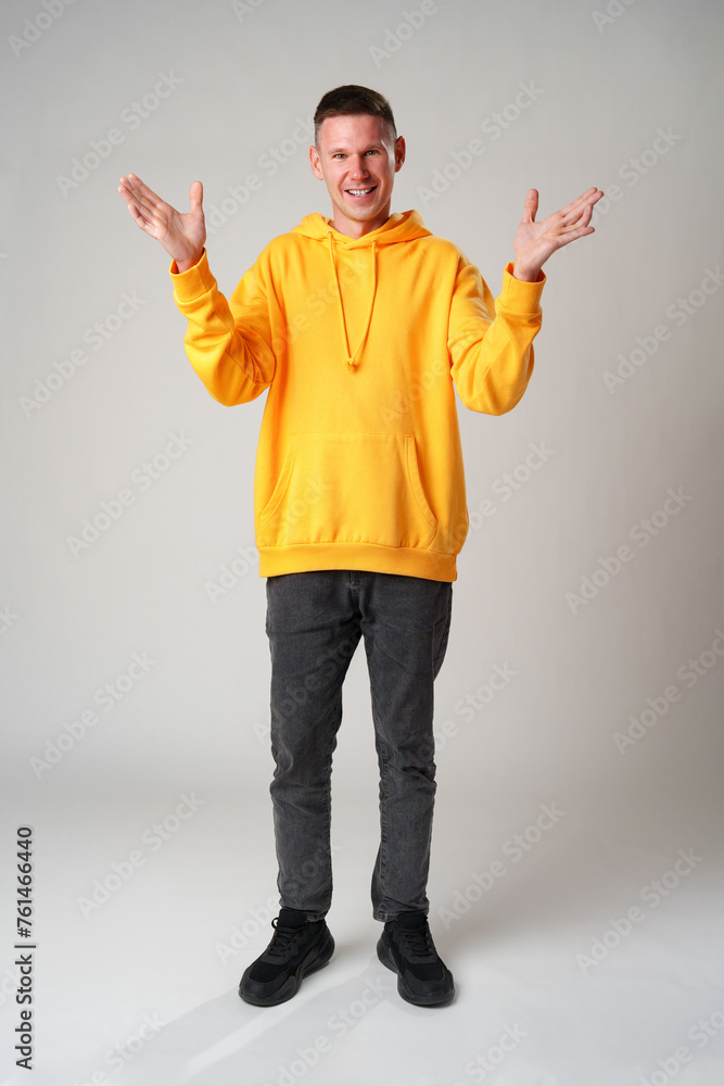 Portrait of surprised young man with shocked facial expression against gray background Portrait of surprised young man with shocked facial expression against gray background