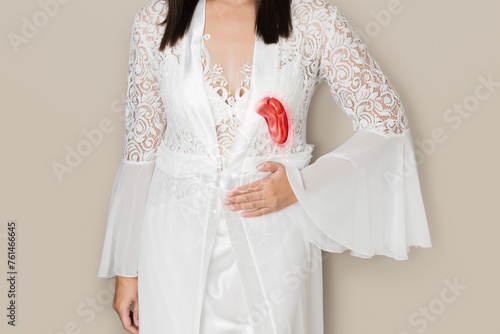 A woman in a white nightwear has an splenomegaly. Symptoms of a Ruptured Spleen photo