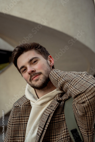 close-up portrait of a young guy. Stylish man in a coat. Portrait of a man