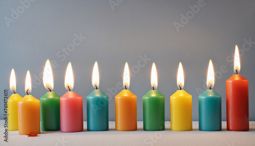 a row of colorful candles shining glowing burning 
