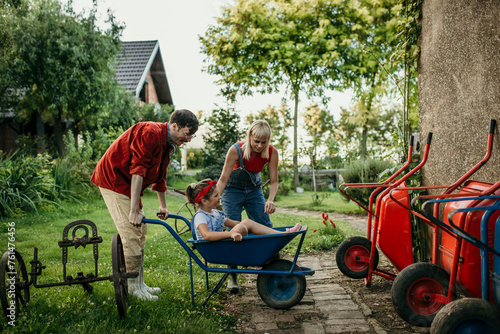 Radiant family immersed in the peacefulness of rural living, bathed in sunlight