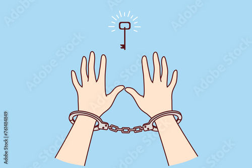 Man in handcuffs reaches for key, wanting freedom and independence, metaphor for solution to problem found. Prisoner sees chance for freedom after unjust court decision that ruined person life