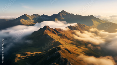 Alpine panorama with several peaks and clouds in the valleys. sunrise over the mountains