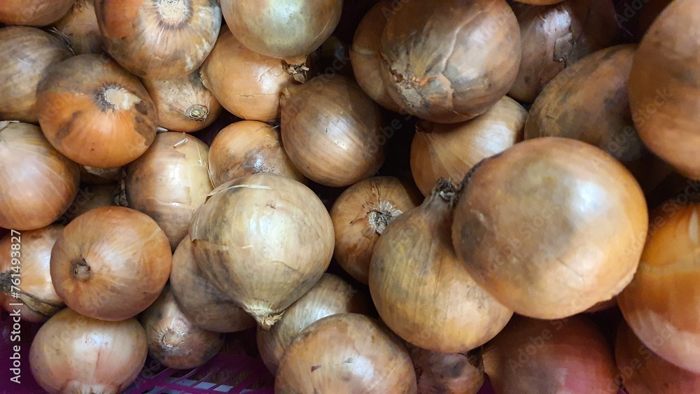 Close up pile of fresh onions placed together in local market as a background. Close up pile of fresh onions placed together in local market as a background.