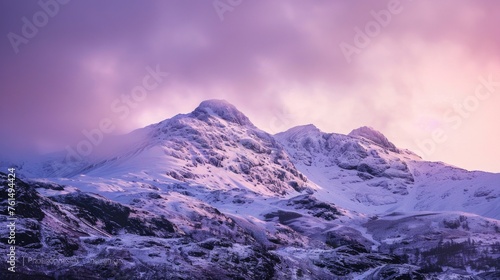 Snow-covered mountain under a cloudy sky, suitable for travel brochures or outdoor adventure websites