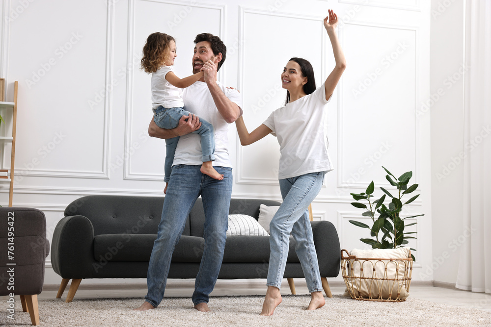 Happy family dancing and having fun in living room, low angle view Happy family dancing and having fun in living room, low angle view