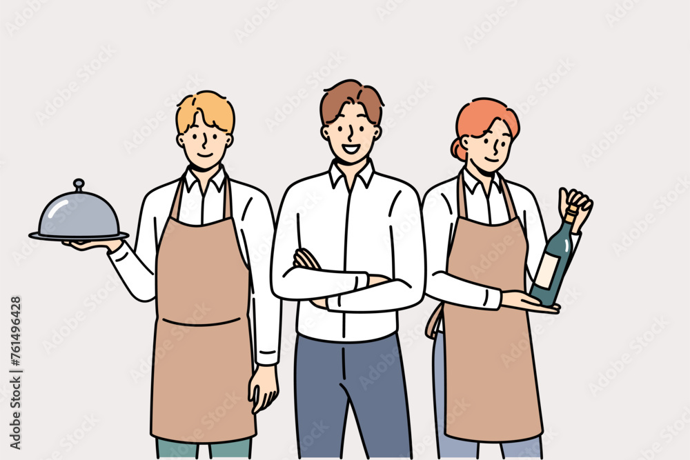 Restaurant waiters and administrators are ready to serve guests, want to have lunch or dinner. Male manager of cafe or lounge bar trains waiters to work in catering and horeca industry Restaurant waiters and administrators are ready to serve guests, want to have lunch or dinner. Male manager of cafe or lounge bar trains waiters to work in catering and horeca industry
