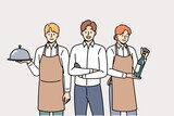Restaurant waiters and administrators are ready to serve guests, want to have lunch or dinner. Male manager of cafe or lounge bar trains waiters to work in catering and horeca industry