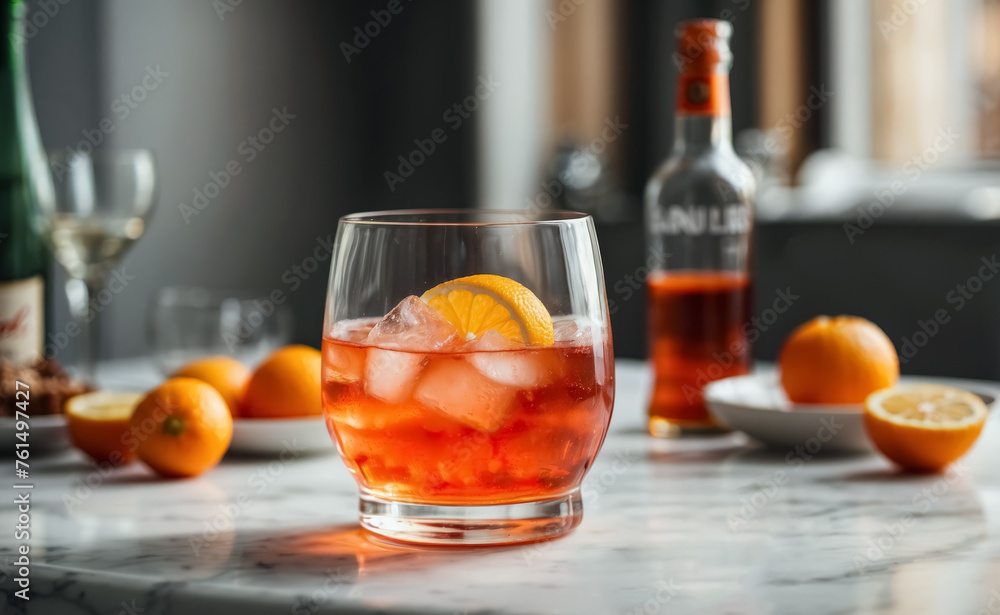 Aperol spritz on a marble table, orange fruits in the background Aperol spritz on a marble table, orange fruits in the background