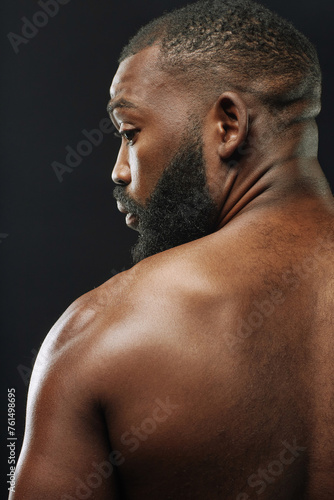 Konstfotografi Vertical over shoulder view of muscular African American man looking sideways