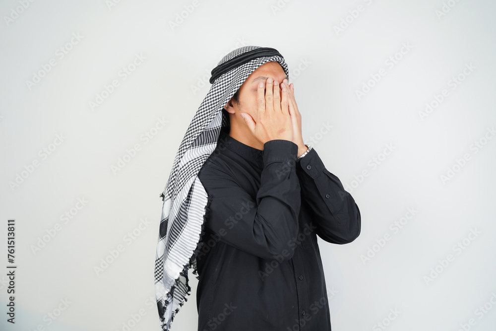 Asian muslim man is praying with hands up, wearing Arab turban sorban in copy space isolated Asian muslim man is praying with hands up, wearing Arab turban sorban in copy space isolated