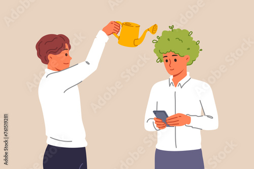 Man manager takes care of employees, uses watering can as metaphor for investing in company personnel. Caring boss develops next generation of company employees for future success.