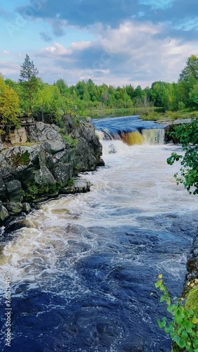 Voytsky padun waterfall in autumn. The famous powerful and wide Karelian waterfall Voytsky Padun is surrounded by rocks and greenery. Cascading waterfall on the river. Karelia, Russia 4K photo