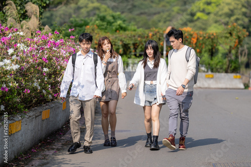 Four Taiwanese college students eat soft serve ice cream in the nature of Maokong, a tourist attraction in Wenshan District, Taipei City, Taiwan 台湾台北市文山区の観光名所の猫空の自然の中でソフトクリームを食べる台湾人の大学生の男女四人