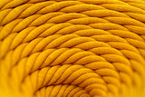 Skein of yellow braided synthetic cord, close-up shot