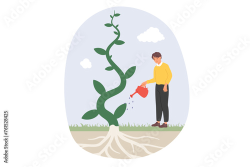 Man waters fantastic tree, enjoying rapid growth plant thanks to high-quality fertilizer that strengthens roots. Eco activist guy takes care of ecology and grows tree, restoring forest and environment