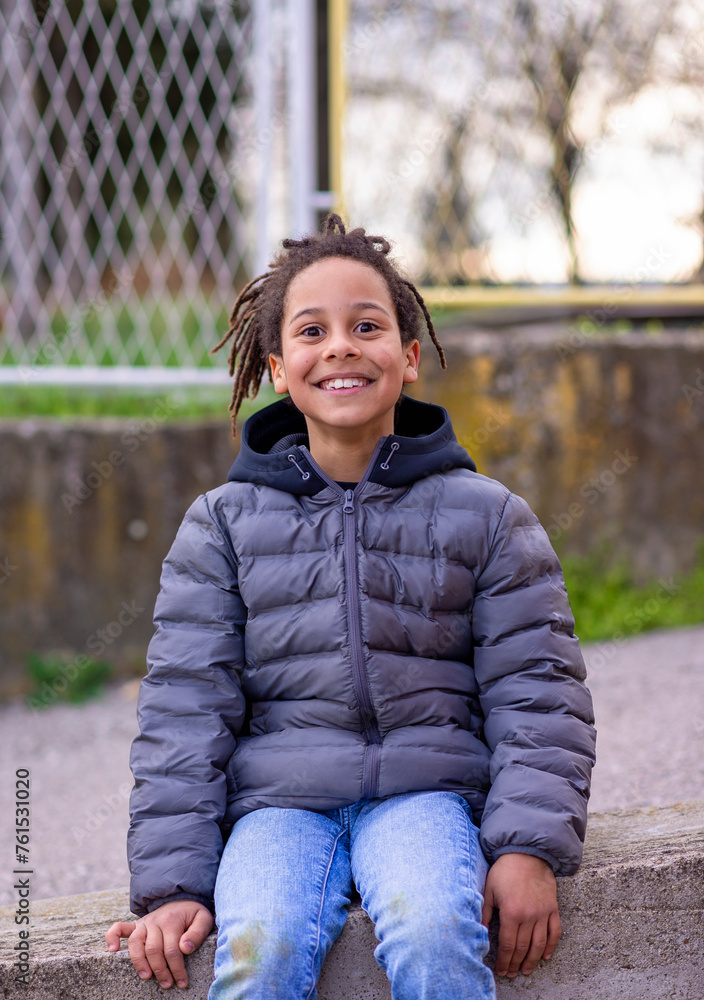 Close up portrait of a happy little boy smiling, looking directly at the camera, laughing. Cute little boy playing outside getting dirty Close up portrait of a happy little boy smiling, looking directly at the camera, laughing. Cute little boy playing outside getting dirty