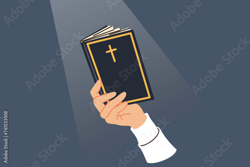 Holy bible in hand of man reading prayers and commandments written by jesus, with christian cross on cover. Religious bible for catholic and orthodox believers studying gospel or old testament