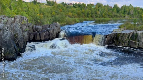 Voytsky padun waterfall in autumn. The famous powerful and wide Karelian waterfall Voytsky Padun is surrounded by rocks and greenery. Cascading waterfall on the river. Karelia, Russia 4K photo