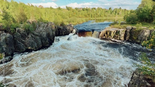 Voytsky padun waterfall in autumn. The famous powerful and wide Karelian waterfall Voytsky Padun is surrounded by rocks and greenery. Cascading waterfall on the river. Karelia, Russia 4K photo