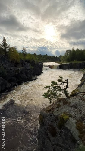 Voytsky padun waterfall in autumn. The famous powerful and wide Karelian waterfall Voytsky Padun is surrounded by rocks and greenery. Cascading waterfall on the river. Karelia, Russia 4K photo