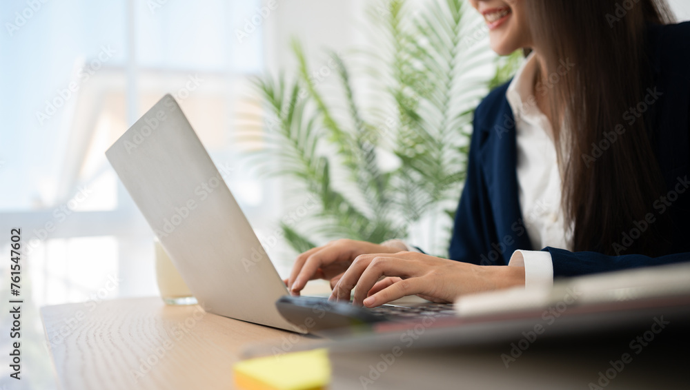 Portrait of smiling beautiful business asian woman at modern office desk using laptop to work and write notes, Business people employee freelance online marketing e-commerce telemarketing concept. Portrait of smiling beautiful business asian woman at modern office desk using laptop to work and write notes, Business people employee freelance online marketing e-commerce telemarketing concept.