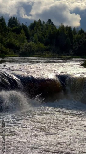 Voytsky padun waterfall in autumn. The famous powerful and wide Karelian waterfall Voytsky Padun is surrounded by rocks and greenery. Cascading waterfall on the river. Karelia, Russia 4K photo