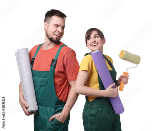Workers with wallpaper rolls and roller on white background