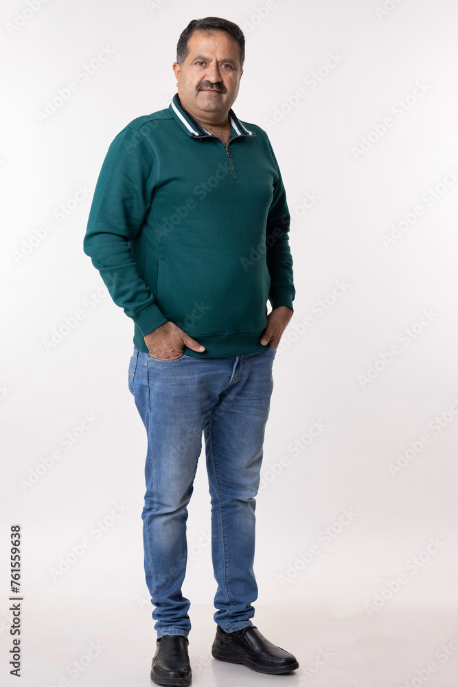 Happy mature man with arms crossed and looking at camera while standing against white background Happy mature man with arms crossed and looking at camera while standing against white background