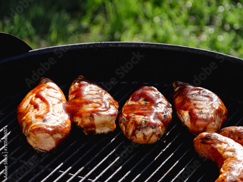 Chicken breasts grilling with bbq sauce outside  © Cam