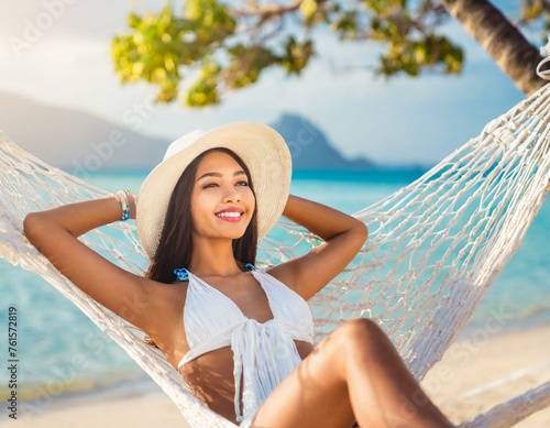 Happy traveler asian woman with white bikini relax in hammock on beach