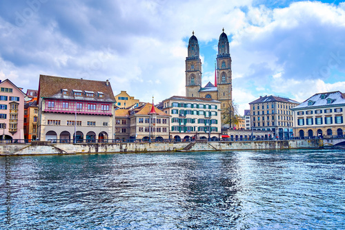 Limmat river and Grossmunster church, houses on the river's bank, Zurich, Switzerland