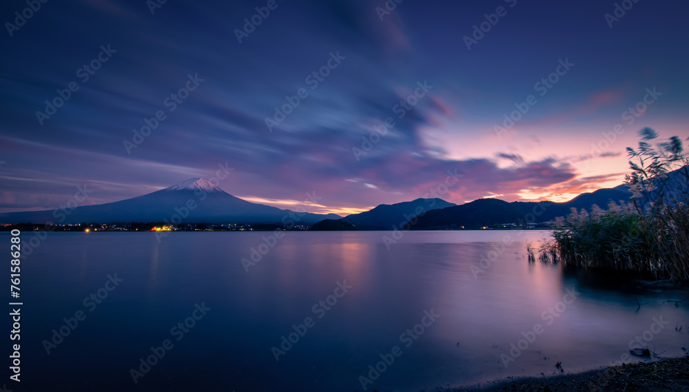 Landscape image of Mt. Fuji over Lake Kawaguchiko at sunset in Fujikawaguchiko, Japan.