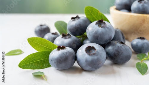 Close-up of raw blueberry fruits with leaves on white floor, South Korea . 