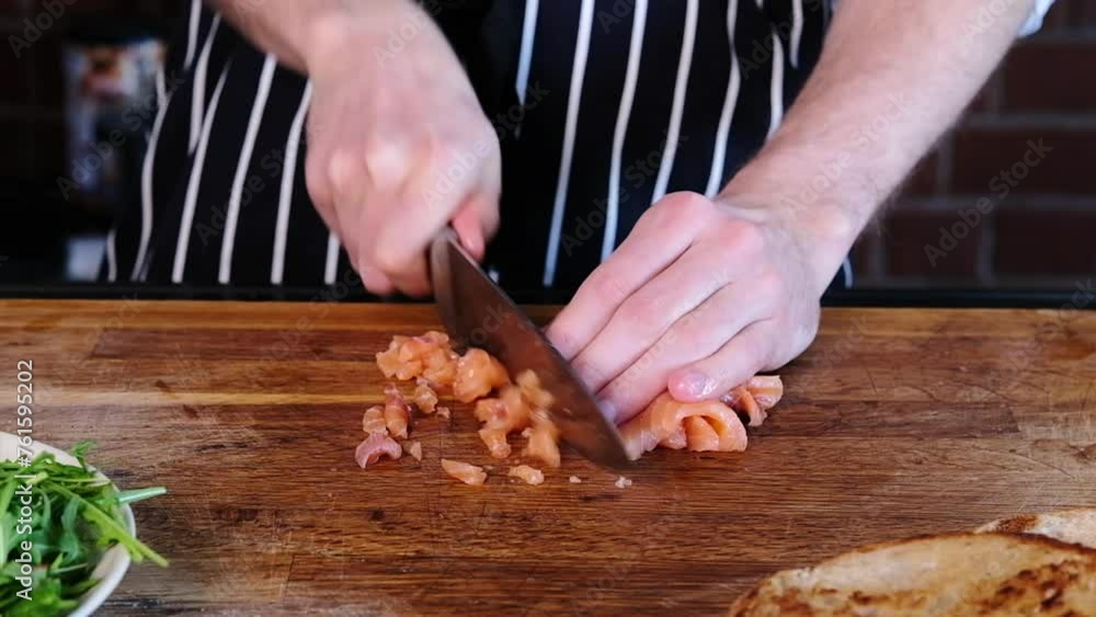 Avocado toast with fresh salmon.Fresh salmon tartare. The chef slices lightly salted fish. Slow mo. Close-up Avocado toast with fresh salmon.Fresh salmon tartare. The chef slices lightly salted fish. Slow mo. Close-up