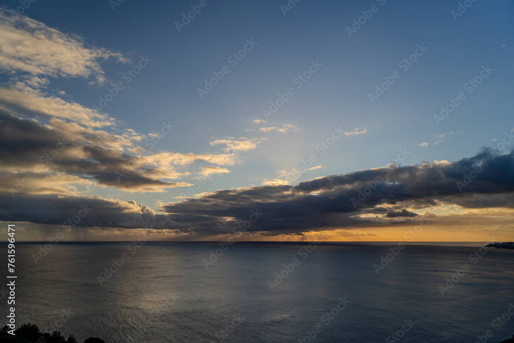 Sunset on the background of the ocean on the island of Madeira, Portugal