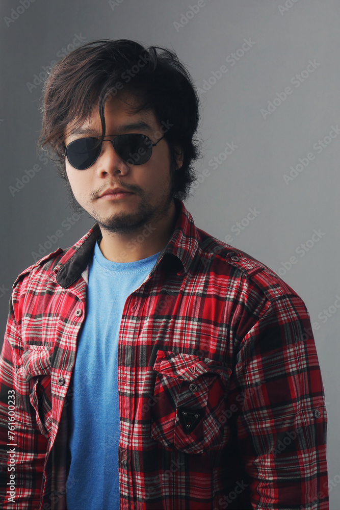 portrait of cool man in sunglasses with low lighting tones portrait of cool man in sunglasses with low lighting tones