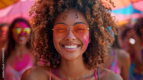 Laughter fills the air as young individuals cheer and celebrate at a daytime summer festival, enjoying the vibrant colors of the Holi festival.