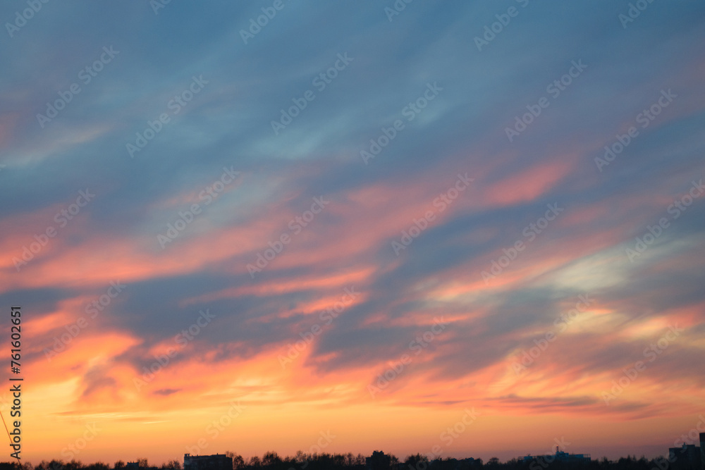 Gray-blue gloomy dull sky at sunset, evening twilight, silhouette of the city on the horizon
