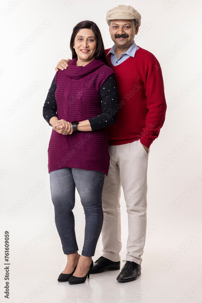 Indian couple in winter wear and warm clothes against white background Indian couple in winter wear and warm clothes against white background