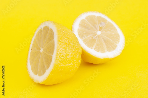 Slices of fresh lemon close up on yellow background
