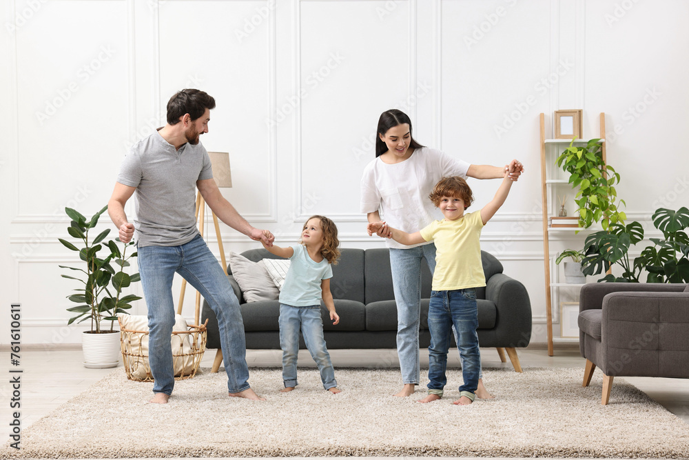 Happy family dancing and having fun in living room Happy family dancing and having fun in living room