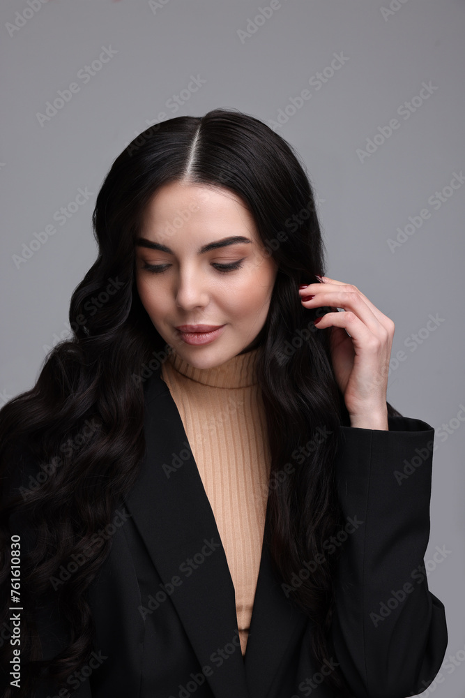 Beautiful woman in black jacket on gray background Beautiful woman in black jacket on gray background