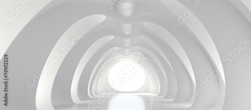 A monochrome tunnel with a gaslike light circling the metal rim, creating a symmetrical pattern on the ceiling. Tints and shades play with the contrast, leading towards the white circle at the end