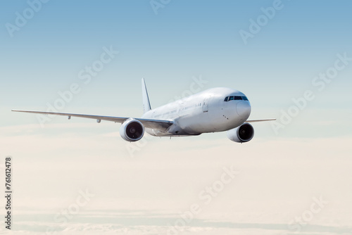 White wide body passenger airliner fly in the air above the clouds