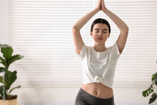 Girl practicing crescent asana in yoga studio. High lunge pose